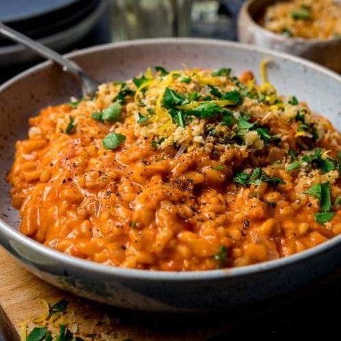 A bowl of creamy tomato risotto with a splash of red wine.