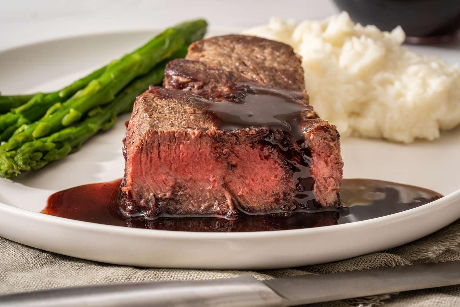  A glass of red wine is a perfect pairing for a juicy steak smothered in wine sauce.