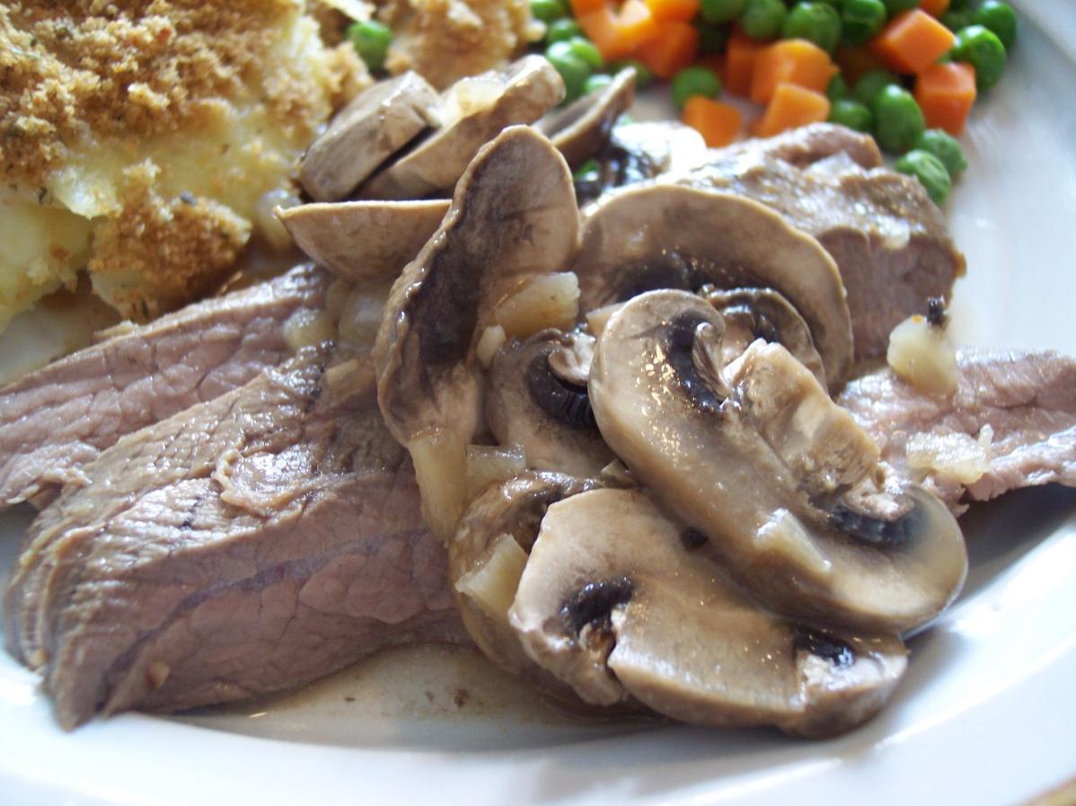 A juicy cut of flank steak smothered in a decadent mushroom wine sauce is sure to satisfy.
