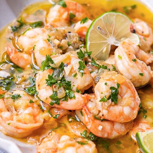  A mouthwatering plate of perfectly cooked shrimp in a flavorful wine sauce.