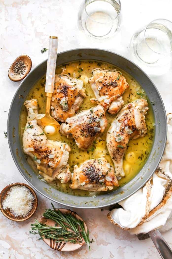  Aromatic garlic and white wine infusing into juicy chicken thighs