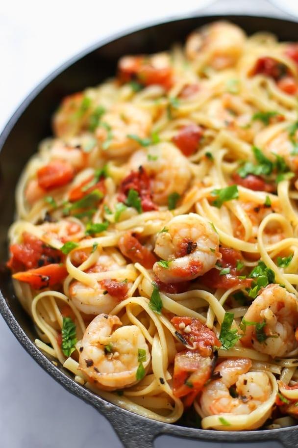  Dive into a bowl of savory linguine with tender shrimp and flavorful tomato white wine sauce