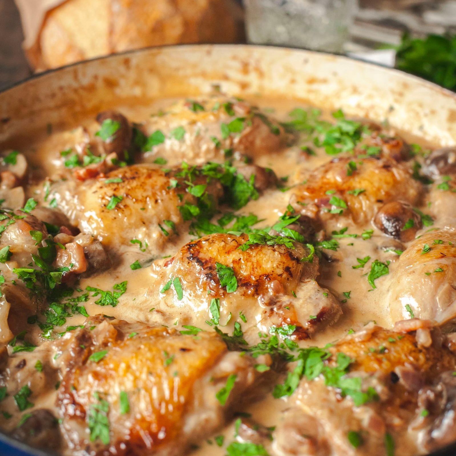  In this recipe, the chicken is cooked slowly in white wine and broth, creating a fork-tender texture.