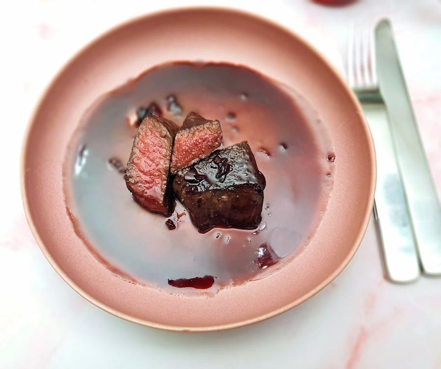  Juicy and flavorful venison steak drizzled with a rich red wine reduction