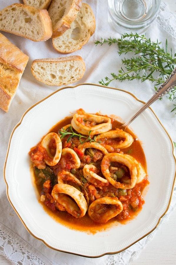  Serve this tomato white wine sauce calamari with crusty bread to mop up the flavorful sauce.
