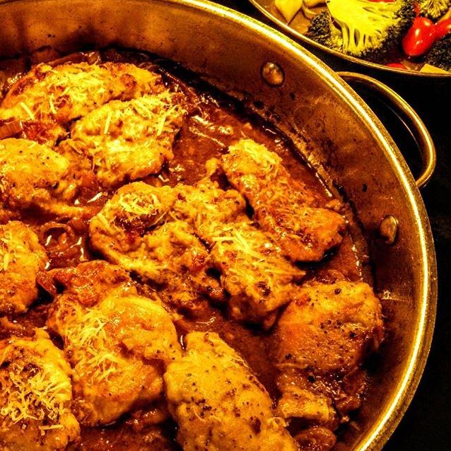  Sizzling chicken thighs soaking up the tangy wine and lemon sauce!