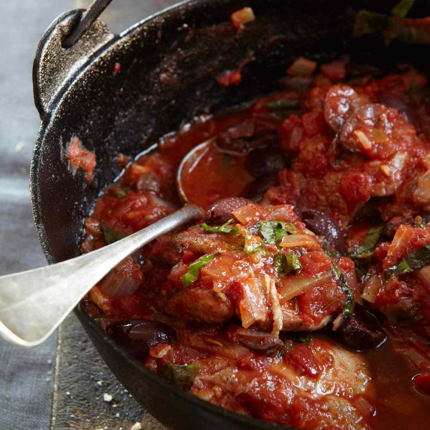  Tender chicken simmered in a flavorful tomato sauce with salty olives.
