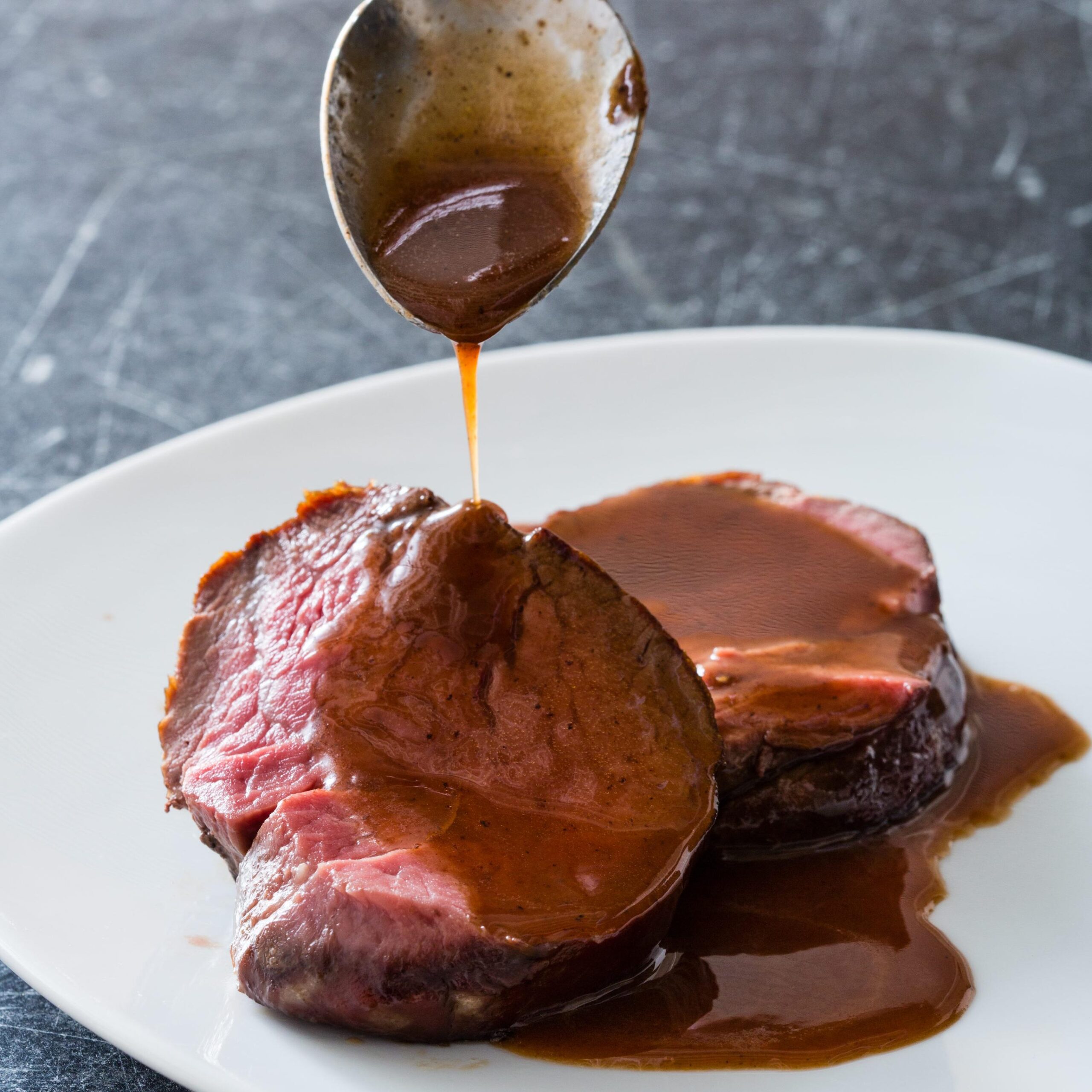  The beef tenderloin may steal the show, but the red wine sauce is the real star of this dish.