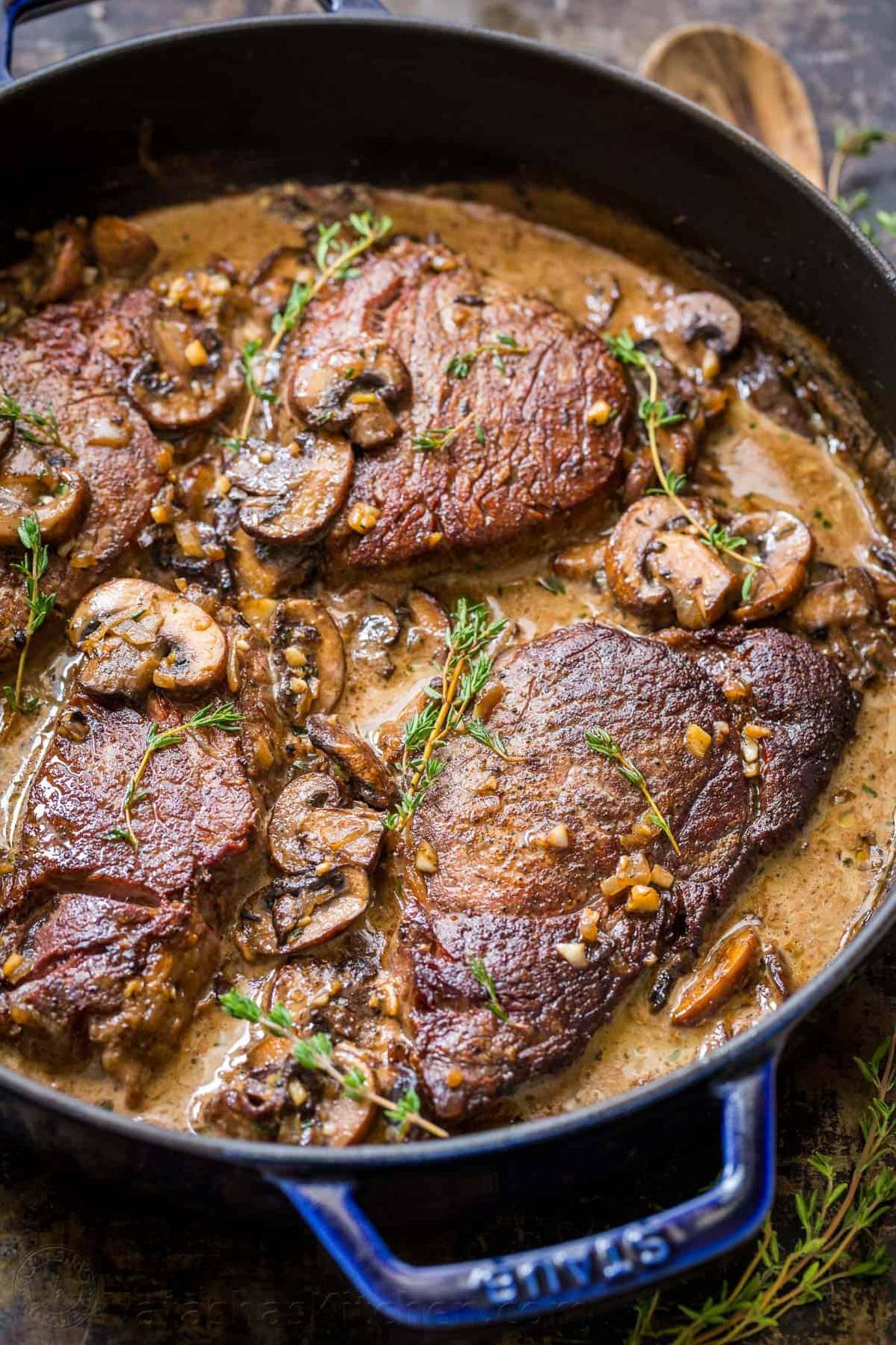  The rich, earthy aroma of the mushroom wine sauce gently smothers the cut of beef and gives it an extra depth of flavor.