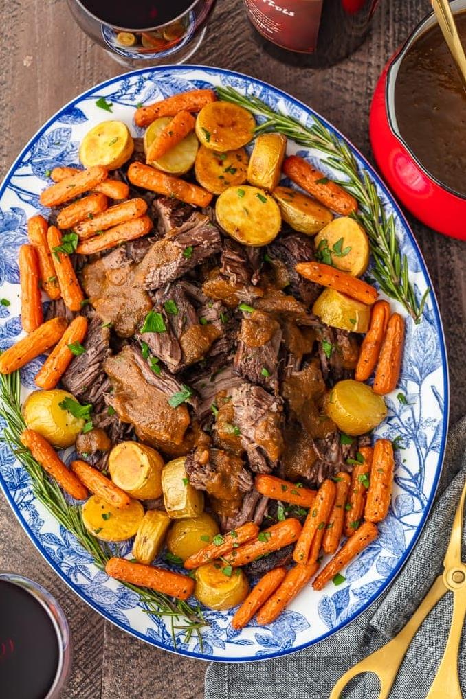  The rich flavors of red wine and garlic seep deep into the melt-in-your-mouth pot roast, making it a true showstopper.