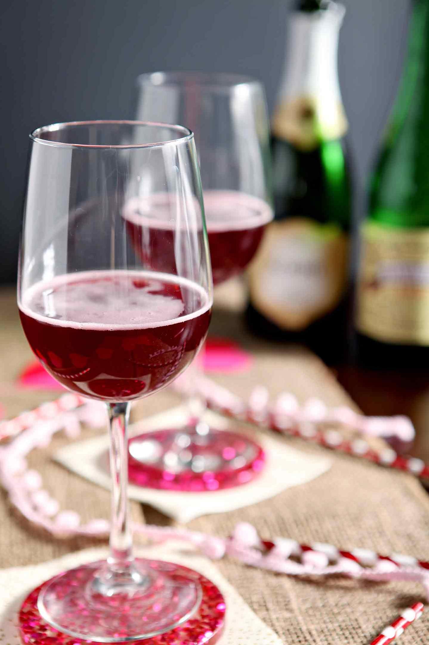  The vibrant colors of raspberries and champagne make for a stunning beverage.